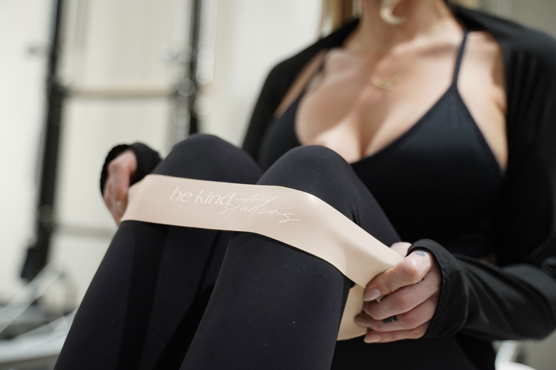 Woman holding a resistance band around her legs during a workout