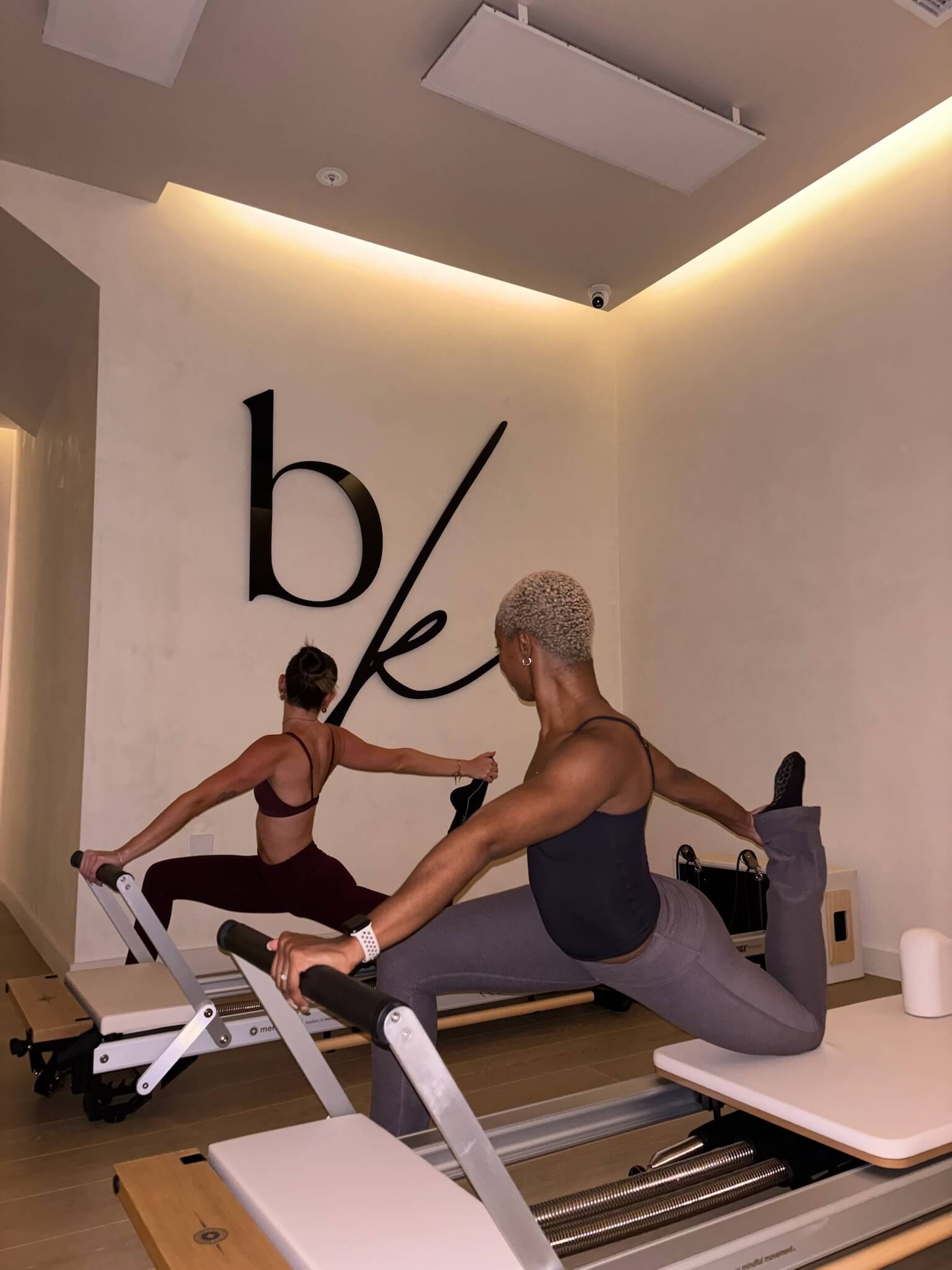two girls taking pilates class at be kind studios