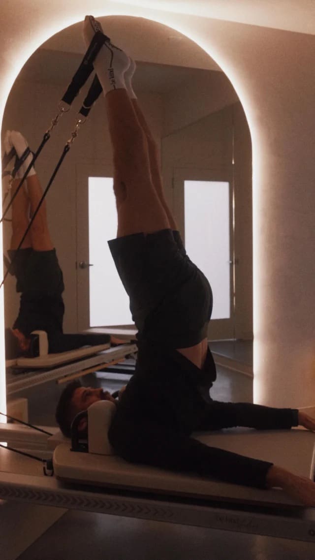 man on pilates reformer