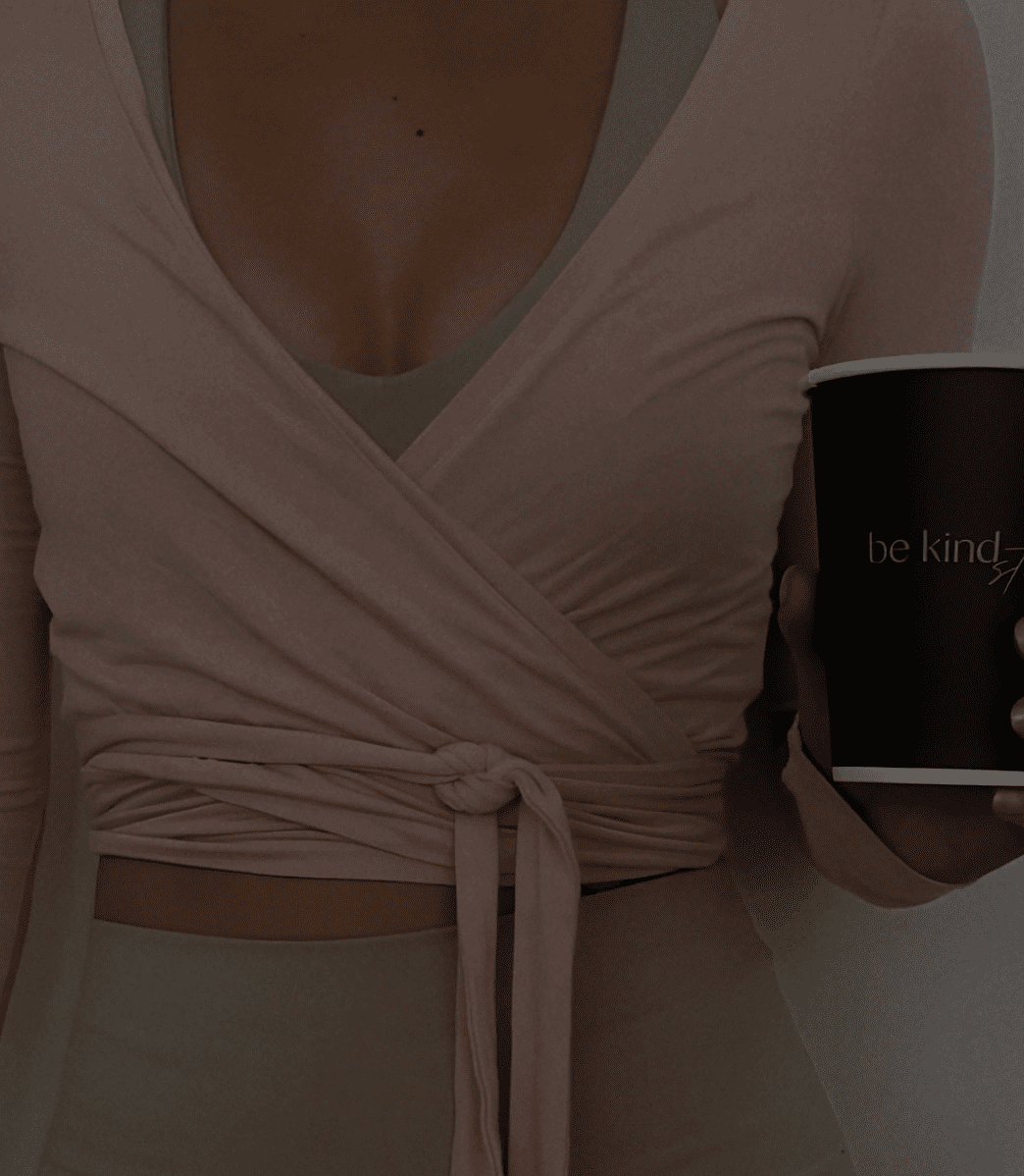 closeup of girl holding coffee cup in pink wrap